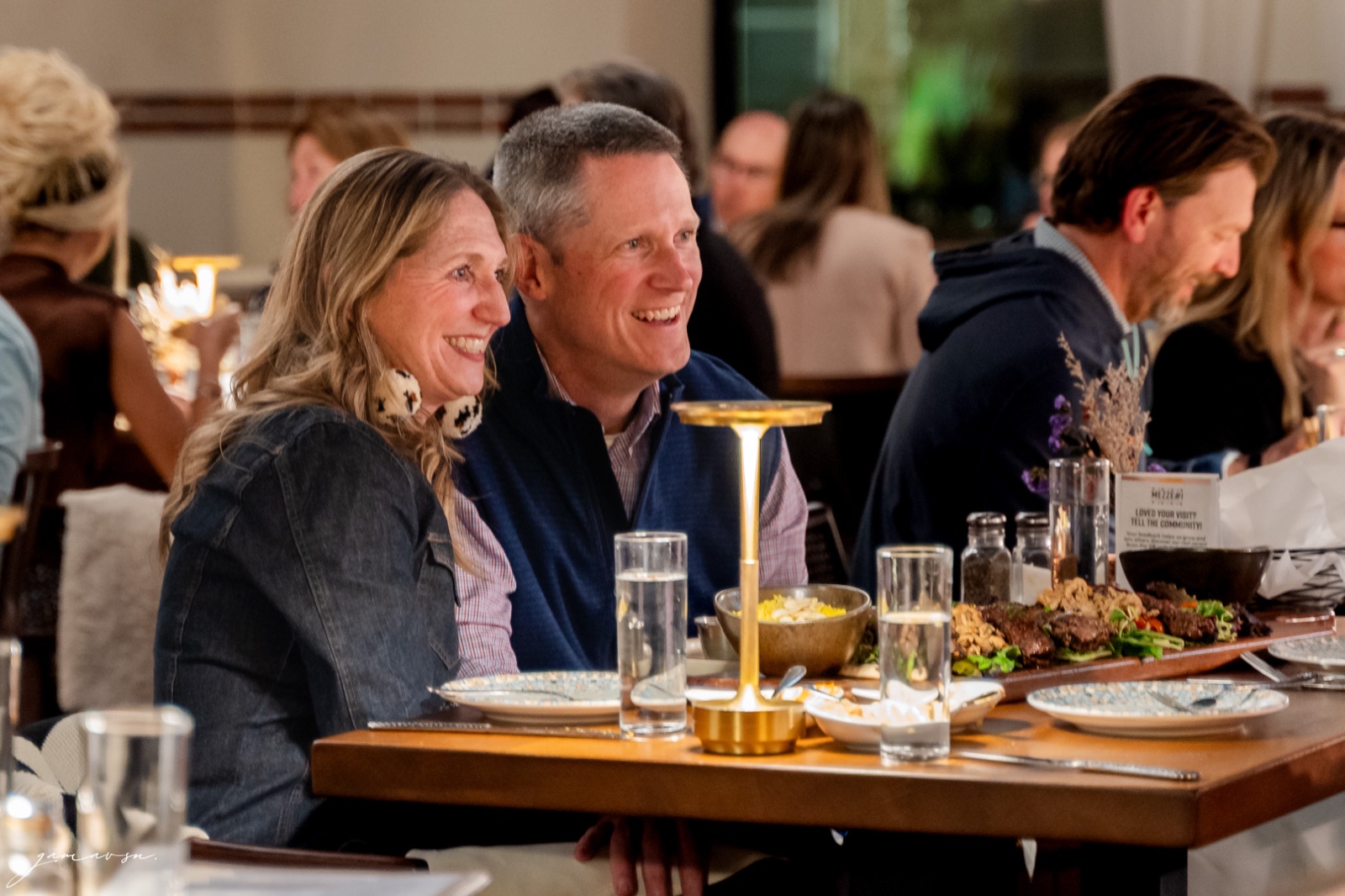 Guests sharing a table and laughing at Mezzé #1