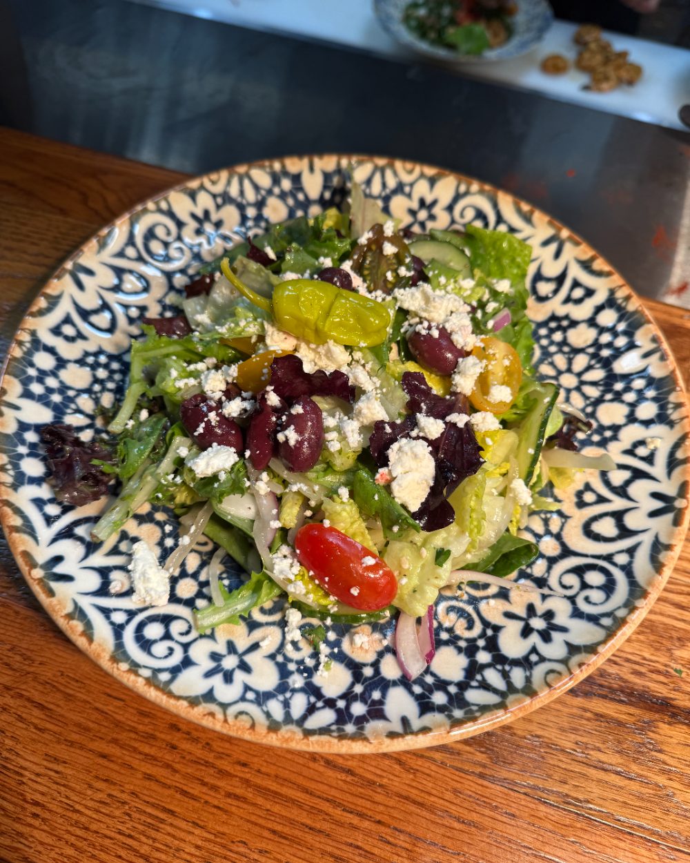 Mezzé #1 Greek salad with feta and fresh vegetables on a patterned plate