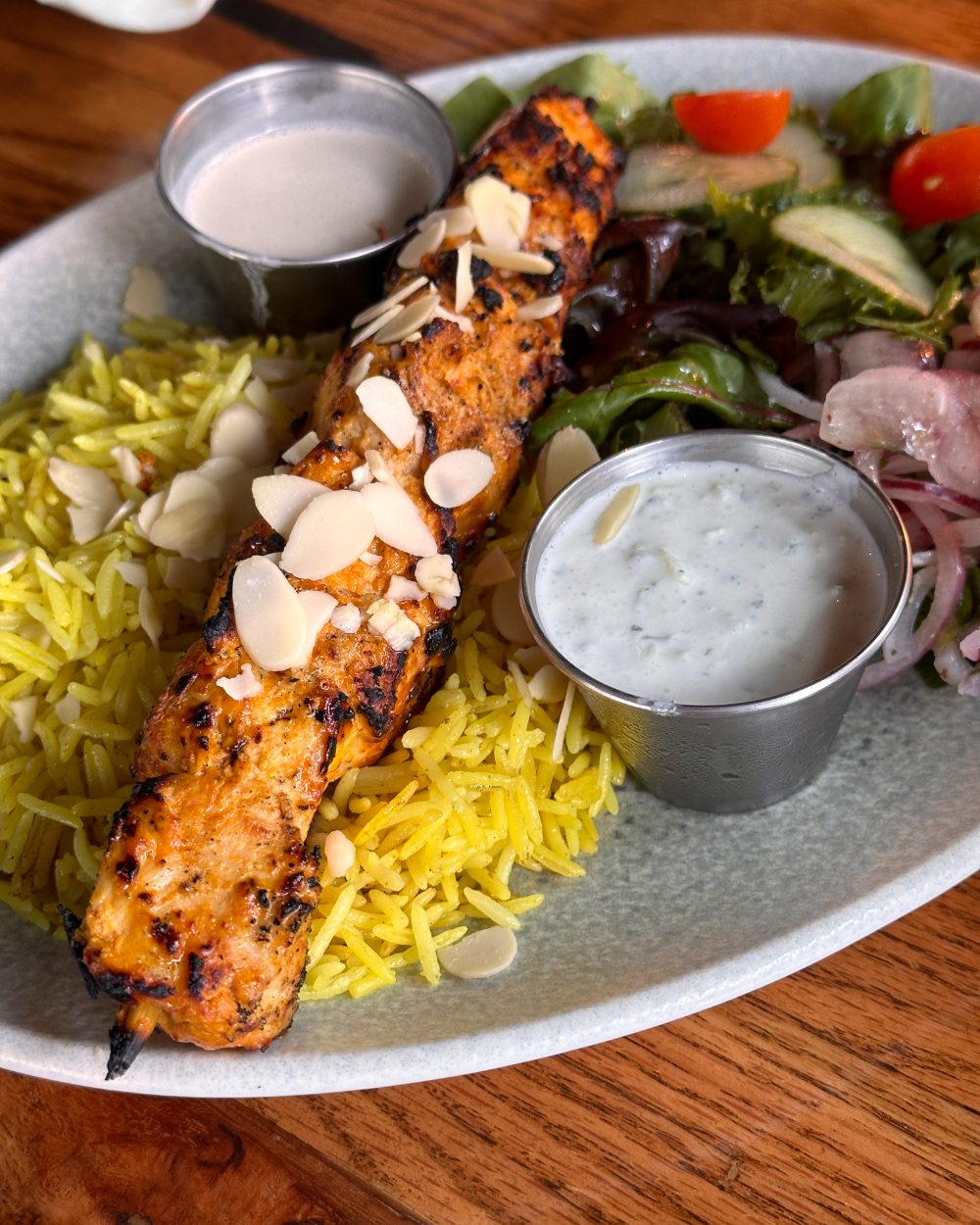 Mezzé #1 chicken tawook skewer with almonds, basmati rice, and salad
